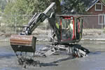 Removal of years of accumulated sediment from irrigation pond using Kaiser spider walking excavator.