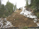 Removing the cut created by the guard on a steep side slope.
